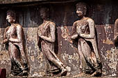 Thailand, Old Sukhothai - Wat Mahathat, stucco frieze runs around the base of the main chedi, it depicts a processions of monks with hands clasped in prayer. 